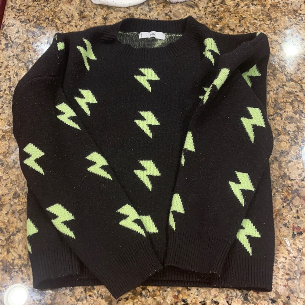 black sweater with electric green lightning bolts